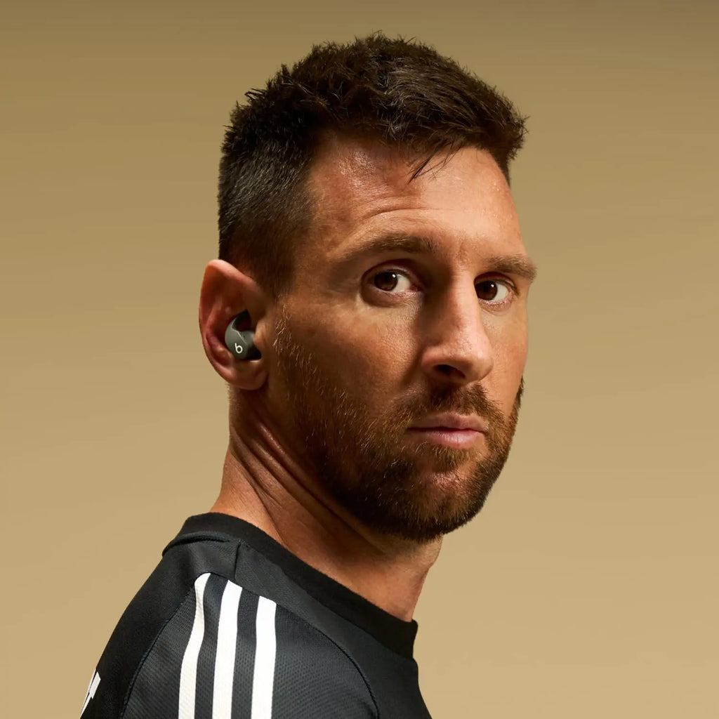 Man wearing black Beats Fit Pro earbuds during workout