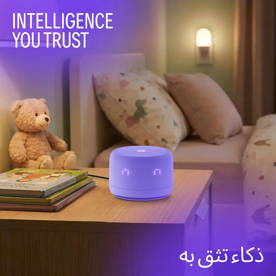 Purple Yasmina Lite AI speaker with glowing eyes on nightstand beside children's books