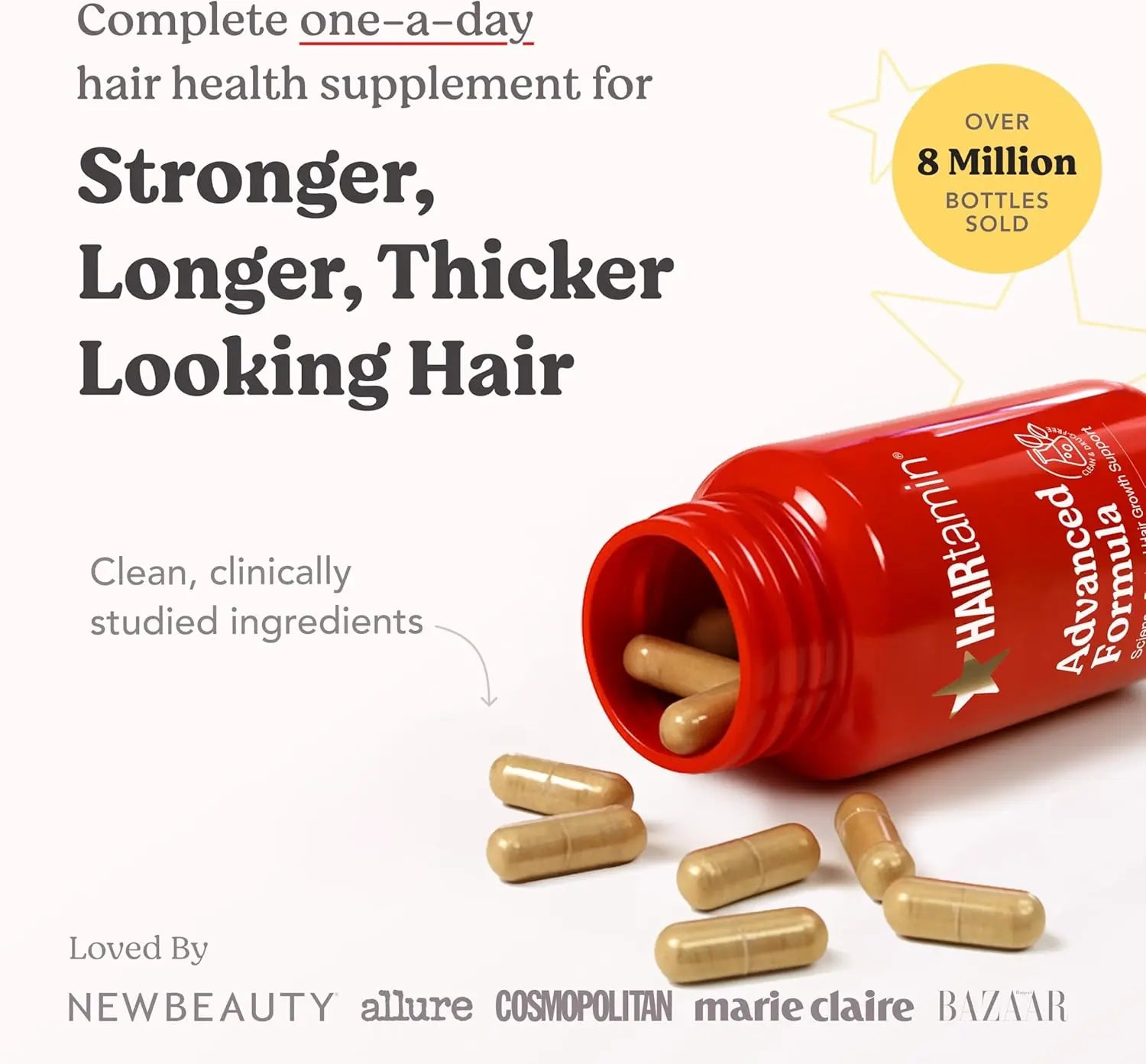 Spilled HAIRtamin capsules from red bottle showcasing clean clinically studied ingredients