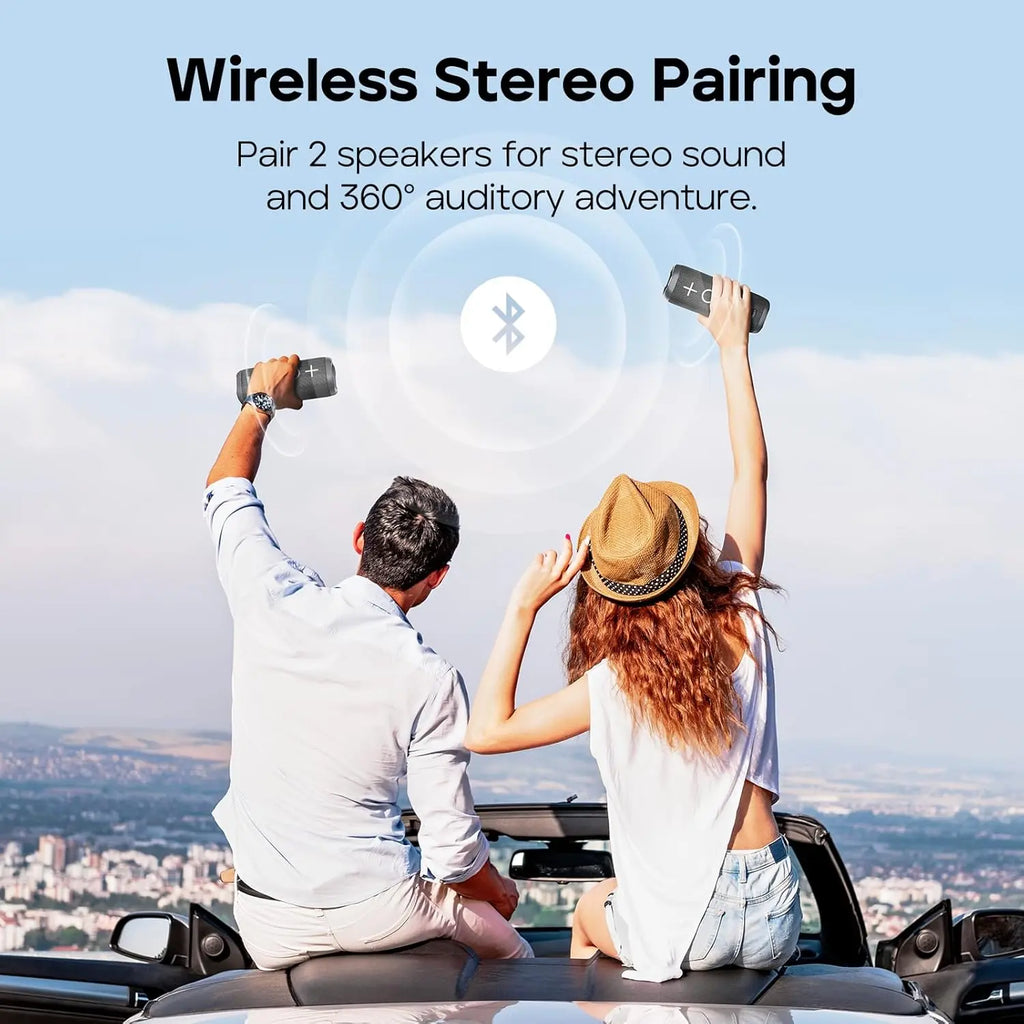 Couple using wireless stereo pairing feature on two Tribit StormBox speakers in car