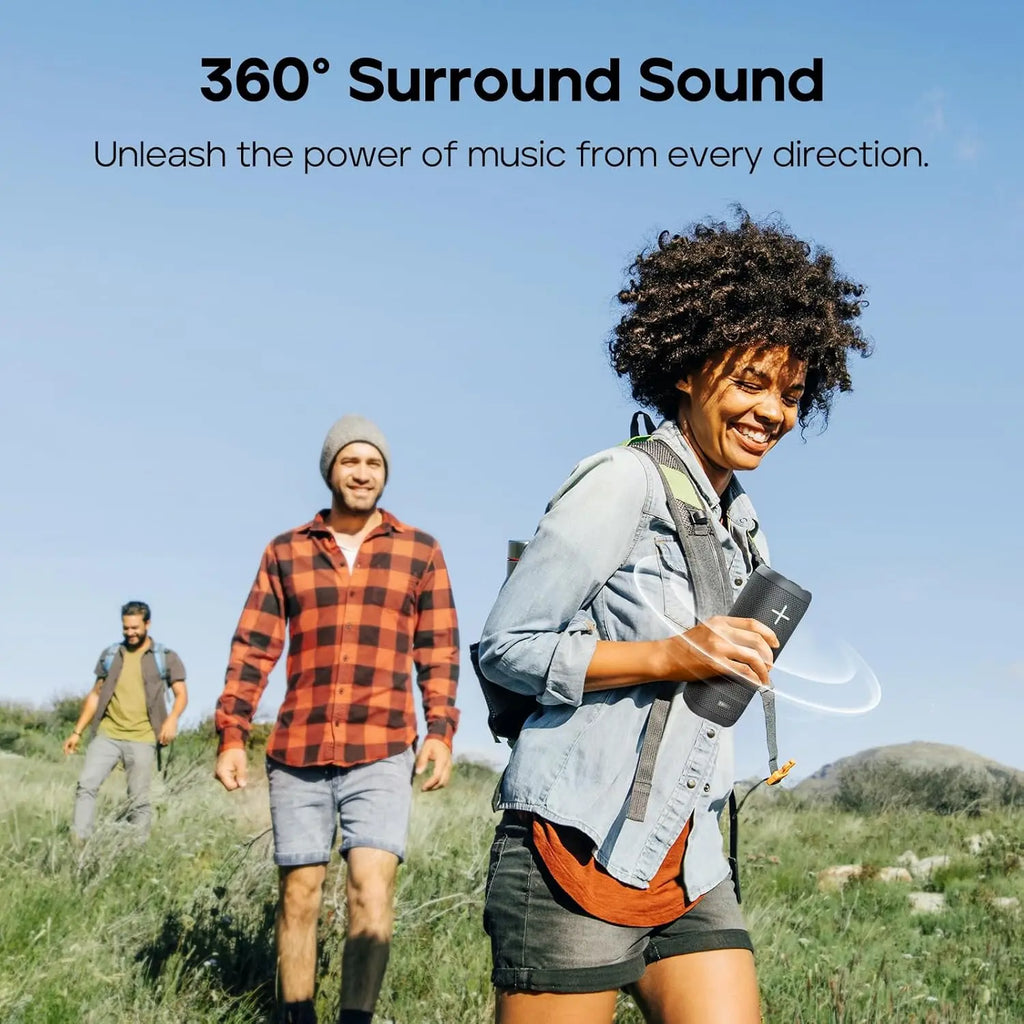 Woman carrying Tribit StormBox outdoor speaker demonstrating 360-degree surround sound
