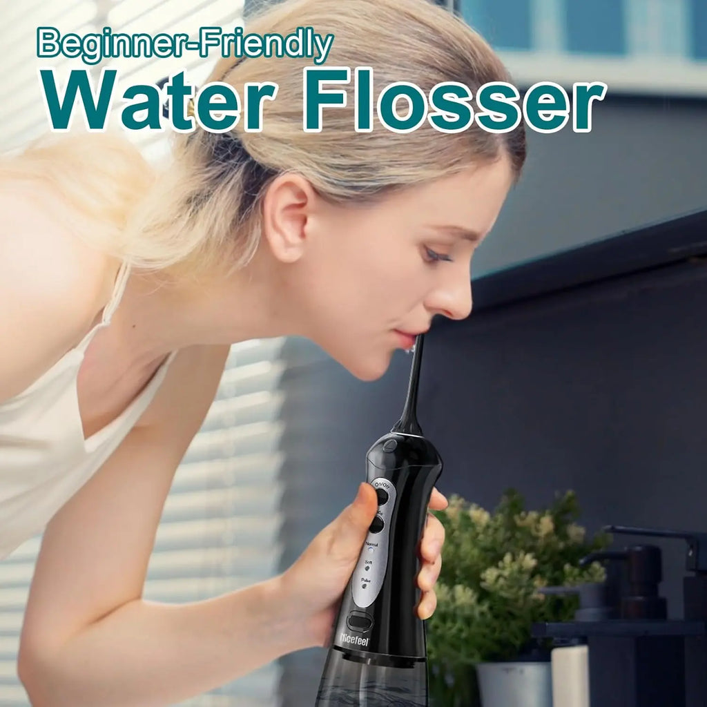 Woman using black portable oral irrigator for beginner-friendly dental care