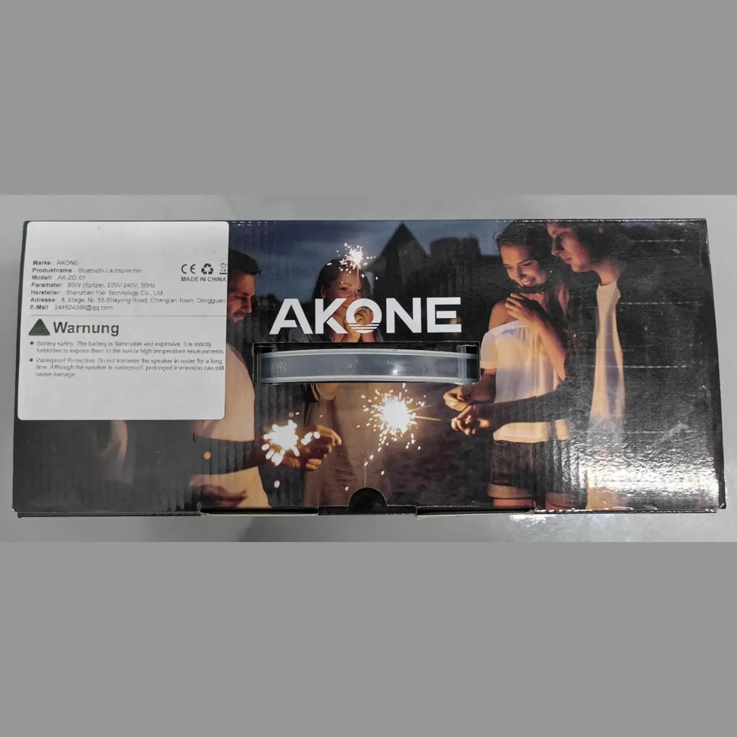 AKONE speaker box with transparent window showing LED bar and CE safety labels