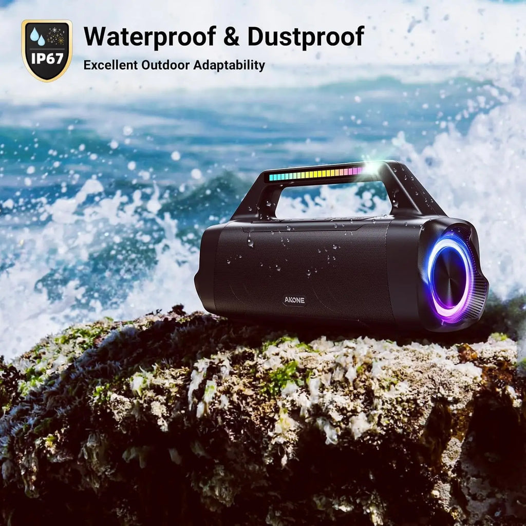Waterproof AKONE black speaker with IP67 rating on rocky beach with water droplets