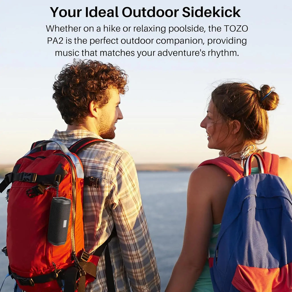 Black TOZO speaker attached to backpack strap via cord buckle design