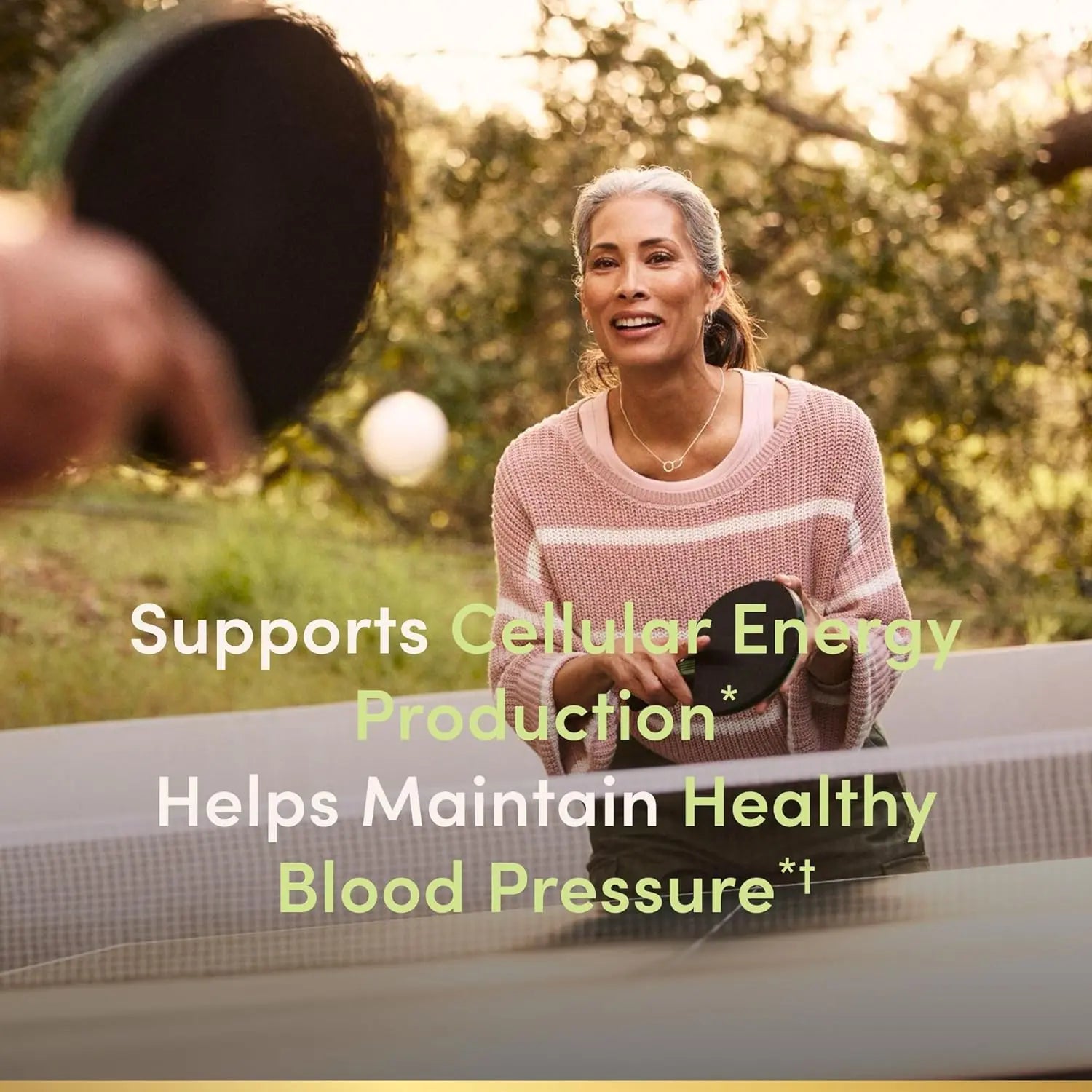 Woman playing table tennis with Nature's Bounty Co Q-10 cellular energy support
